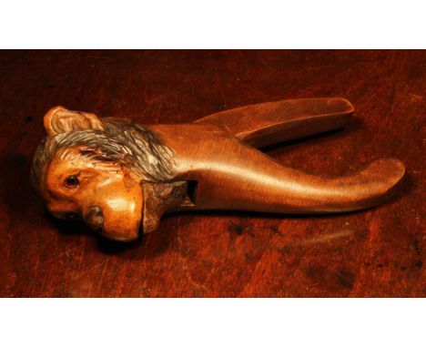 Nutcrackers - a Black Forest novelty lever-action novelty nut cracker, carved as the head of a monkey, glass eyes, 20.5cm lon