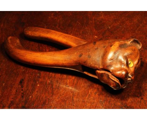 Nutcrackers - a Black Forest novelty lever-action nut cracker, carved as the head of a cat, glass eyes, 21.5cm long, c.1900 