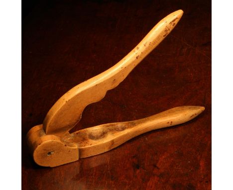 Nutcrackers - a 19th century boxwood lever-action nut cracker, with provision for two sizes of nut, brass pivot pin, 23.5cm l