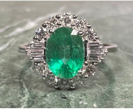 A certified emerald and diamond ring, central oval cut emerald, 1.46ct, surrounded by sixteen round brilliant and baguette cu