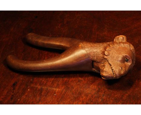 Nutcrackers - a Black Forest novelty lever action nut cracker, carved as the head of a monkey, glass eyes, painted teeth, 21c