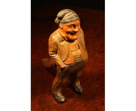 Nutcrackers - a Black Forest novelty lever-action nut cracker, carved and painted as a gentleman wearing a tasselled cap, 21c