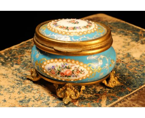 A 19th century French gilt metal mounted enamel oval jewel casket, painted with flowers within 'jewelled' reserves on a bleu 