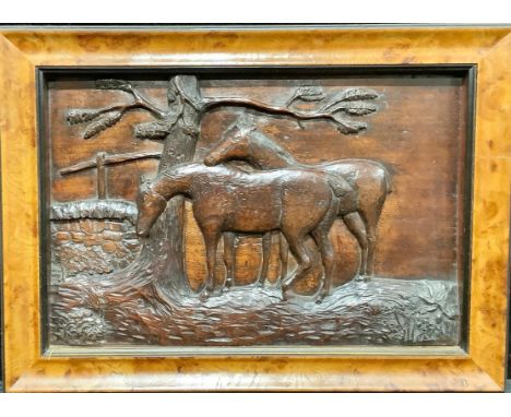 A 19th century mahogany primitive folk art panel, carved in relief with horses beside a tree, 27.5cm x 42cm, framed 
