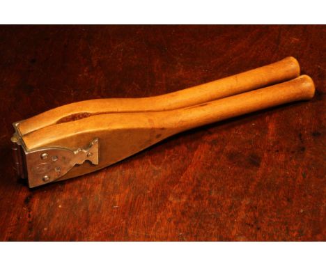 Nutcrackers - a George III silver mounted boxwood lever-action nut cracker, goblet shaped hinge, 26cm long, Thomas Phipps &am