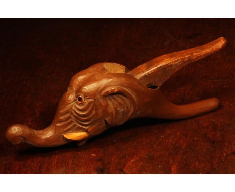 Nutcrackers - a Black Forest novelty lever-action nut cracker, carved as the head of an elephant, 26cm long, early 20th centu