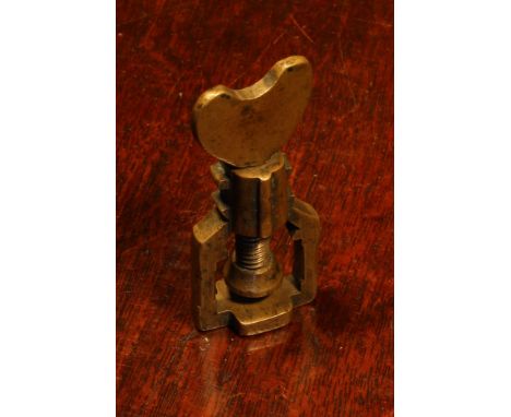 Nutcrackers - a late 17th century brass screw-action pocket corkscrew, heart shaped thumbpiece, 7.5cm long, c.1670 - 1700 