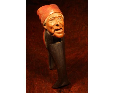 Nutcrackers - a Black Forest novelty lever-action nut cracker, carved and painted as a gentleman wearing a red cap, 17.5cm lo