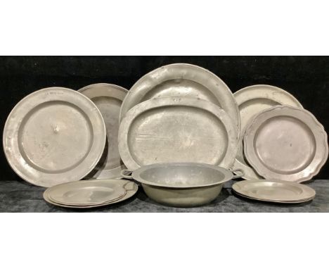 Pewter - a George III circular charger, 46cm diam, c.1800; a two-handled pan or basin, 40cm diam; other plates and platters (