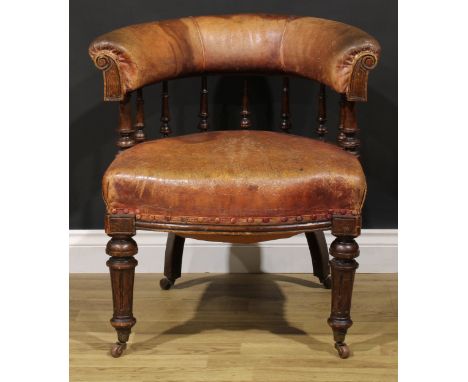 A Victorian oak club elbow chair, stuffed-over upholstery, turned and fluted forelegs, ceramic casters, 74cm high, 69cm wide,