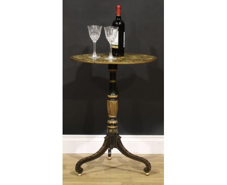 A 19th century painted, ebonised and parcel-gilt tripod wine table, the oval top decorated with a patera and bands of flowers