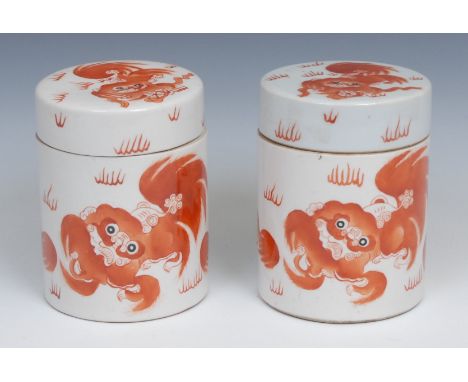 A pair of Chinese cylindrical jars and covers, each painted in iron red with Shī-shì and inscribed with verse, printed seal m