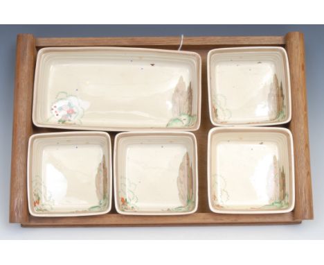 A Clarice Cliff hors d'oeuvre set, comprising one rectangular and four square dishes, printed marks, hardwood tray, 37cm wide