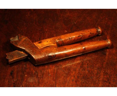 Nutcrackers - an 18th century yew wood crossover lever-action nut cracker, scrimshaw engraved with naive primitive portrait o