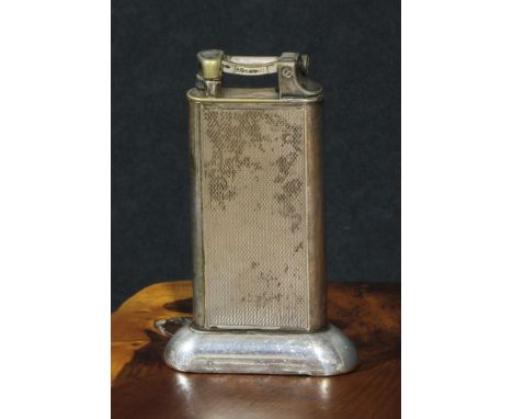 Dunhill - a mid-20th century E.P.N.S table cigarette lighter, engine turned, 10cm high 