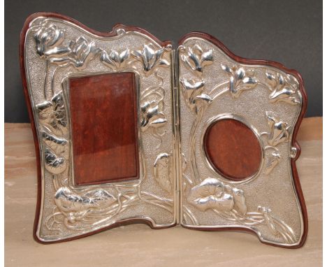 An Art Nouveau silver diptych photograph frame, embossed with irises on stylised whiplash stems, on a textured ground, 21.5cm