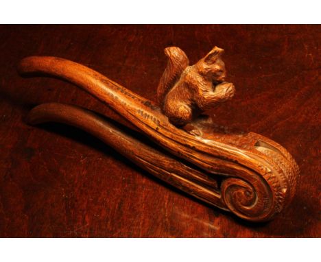 Nutcrackers - a Black Forest novelty lever-action nut cracker, carved as a squirrel on a branch, 22cm long, c.1870 