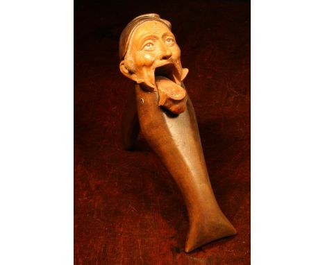 Nutcrackers - a Black Forest novelty lever-action nut cracker, carved and painted as a gentleman wearing a tasselled cap, 22c