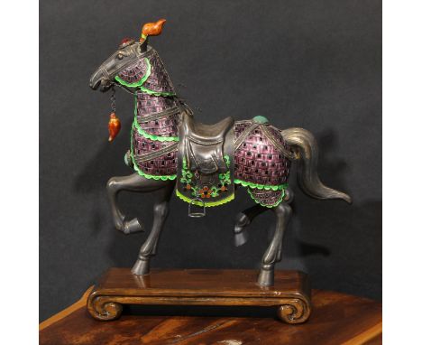 A Chinese silver and enamel model, of a horse ceremonially dressed, the bridle set with a cabochon, marked Silver, 34cm high 