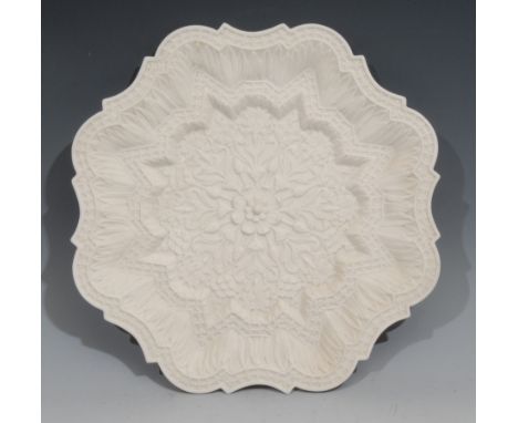 A Royal Worcester parian shaped circular plate, moulded in the Orientalist taste with lotus, 30.5cm diam, impressed crown and