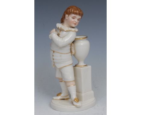 A Royal Worcester figure, of a boy stood next to a vase and pedestal, picked out in flesh tones and gilt, 17cm high, impresse