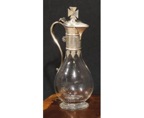 A Victorian Gothic Revival silver mounted clear glass ovoid Communion flagon, hinged cover with cross finial, 19cm high, Lond