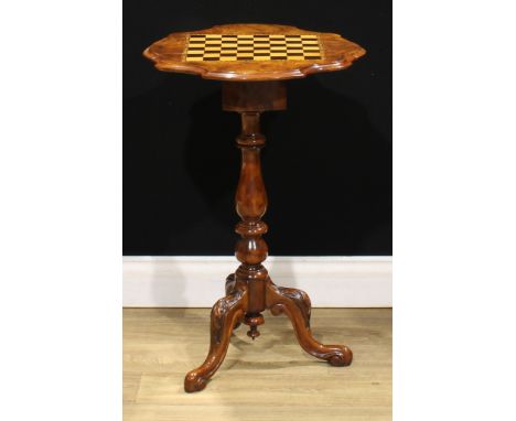 A Victorian walnut tripod games table, shaped top with fall leaves inlaid for chess, above two frieze drawers, turned column,