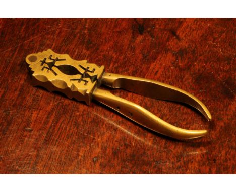 Nutcrackers - an unusual 18th century brass lever-action nut cracker, the jaws shaped and pierced in work reminiscent of that