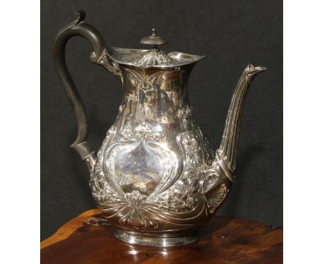 An Art Nouveau silver coffee pot, chased with stylised flowers and sinuous whiplash lines, hinged cover, ebonised finial and 