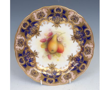 A Royal Worcester shaped circular plate, painted by Albert Shuck, signed, with ripe pears and raspberries, within fancy gilt 