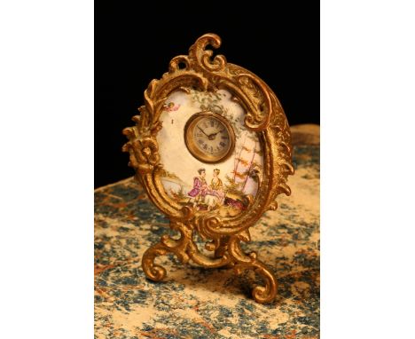 An early 20th century gilt metal mounted enamel cartouche shaped boudoir timepiece, 1.75cm circular clock dial inscribed with