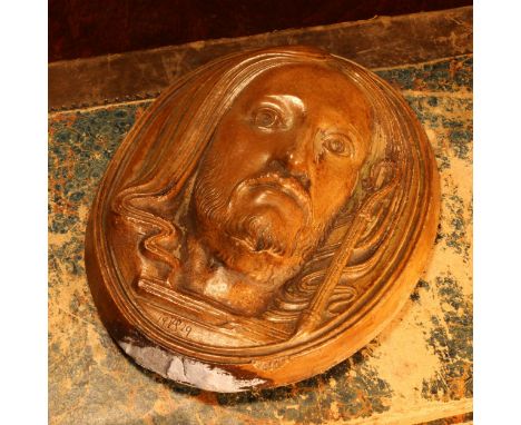 Alfred Lyndhurst Pocock (1882 - 1962), an Arts and Crafts ceramic plaquette, The Head of Christ, 15cm x 11.5cm, painted and i