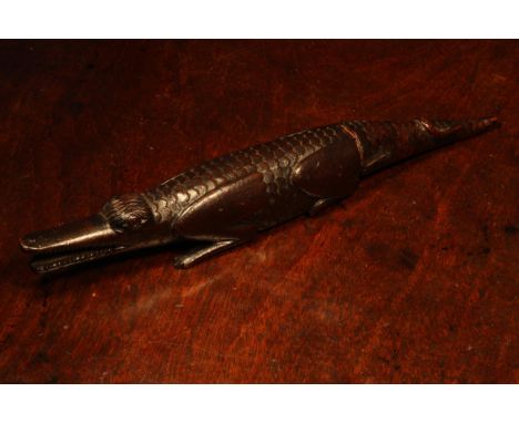 Nutcrackers - an early 19th century novelty screw-action nut cracker, carved as a crocodile, the tail twisting, 29cm long, c.