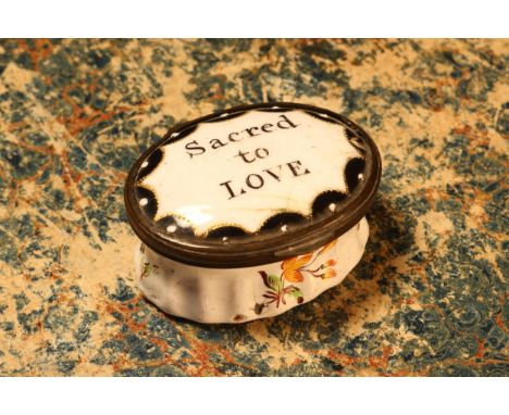A George III South Staffordshire enamel oval patch box, hinged cover inscribed Sacred to Love, the fluted base painted with s