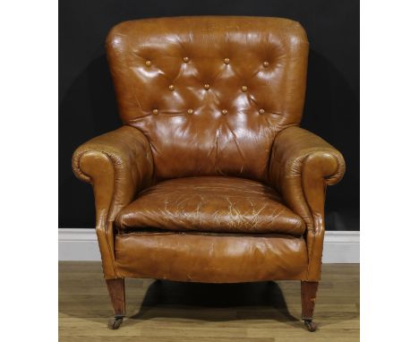 An early 20th century club armchair, stuffed-over upholstery, tapered square forelegs, ceramic casters, 91cm high, 84cm wide,