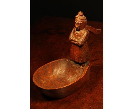 Nutcrackers - an early 20th century oak folk art table top nut cracker, naively carved as a figure standing on the side of a 