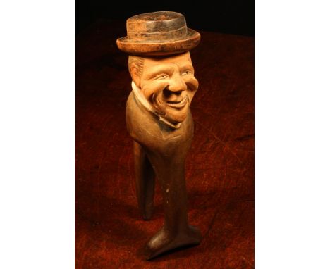 Nutcrackers - a Black Forest novelty lever-action nut cracker, carved and painted as a gentleman wearing a brimmed hat, 22cm 
