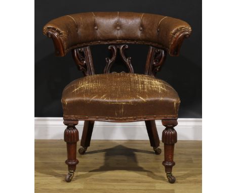 A Victorian mahogany club or desk chair, stuffed-over upholstery, turned legs, ceramic casters, 73cm high, 71cm wide, the sea