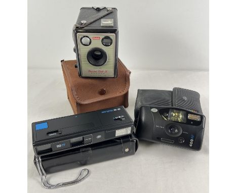 3 vintage cased cameras. A Kodak Brownie Flash III boc camera, in brown canvas case, together with 2 more modern cameras from