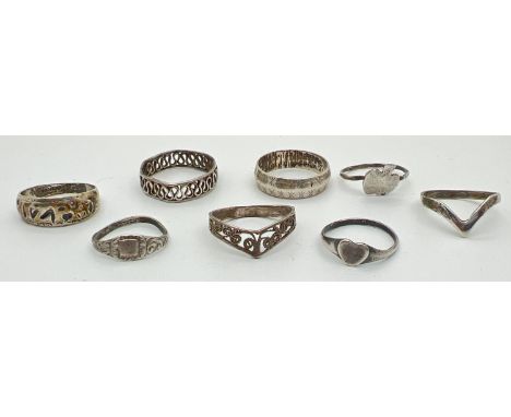 8 silver and white metal rings, mostly band style. To include Mizpah, wishbone and heart shaped signet ring. Sizes F, H, K, L