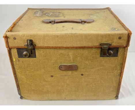 A vintage canvas and leather trim travelling trunk  with initials N.L. to top. Leather hadle to top woth brass catches and fi