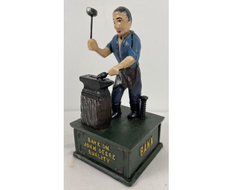 A painted cast iron square based mechanical money bank featuring John Deere. With nodding head and swinging arm action with p