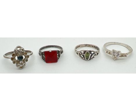 4 silver dress rings, all stone set. To include an Art Deco style set with a square cut red stone and a modern design Celtic 