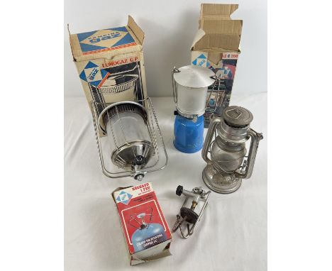 A collection of boxed and unboxed camping equipment, mostly lighting. To include a boxed single burner stove, a boxed Lumigaz