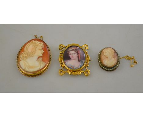 Two shell cameos featuring female heads, both set in gilt metal to/w porcelain portrait of a female in ornate gold set frame 