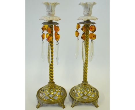 A pair of 19th century Continental candlesticks with ceramic sockets and two-colour glass drops, on brass twist stems and pie