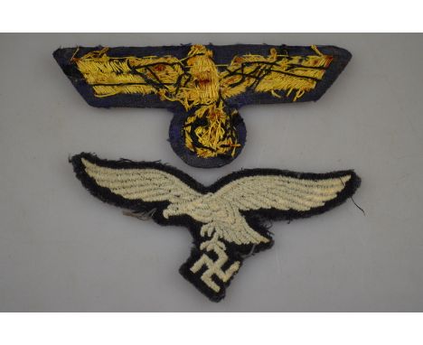 A World War II Third Reich Army cloth and gold thread tunic eagle to/w Luftwaffe fabric eagle, a Luftwaffe marked alloy ladle