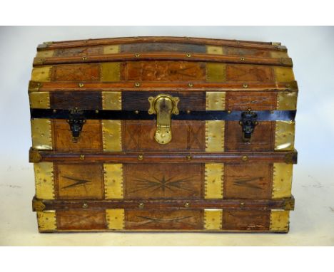 A leather clad and brass bound domed trunk with fitted tray, 58 x 83 x 50 cm Condition Report 57 cm high x 48.5 cm deep x 84 