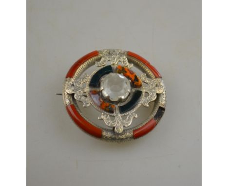 A circular Celtic brooch set with multi-coloured agates with white paste in centre Condition Report A section of agate missin