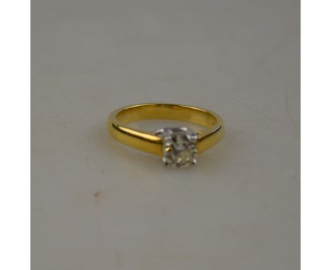 A single stone brilliant-cut diamond ring, 18ct yellow and white gold claw set, approx 0.90 carats, size R Condition Report D